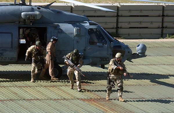 SEALs disembarking helicopter