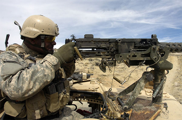 special forces soldier fires m2 machine gun