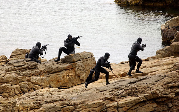 Navy SEALs on rocks