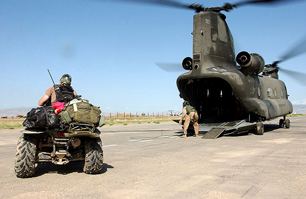 Special forces preparing to drive an ATV into a CH-47 Chinook